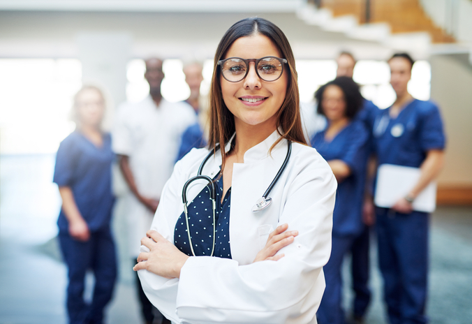 Female doctor standing with medical team