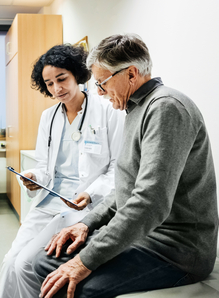 A health professional and older man talking