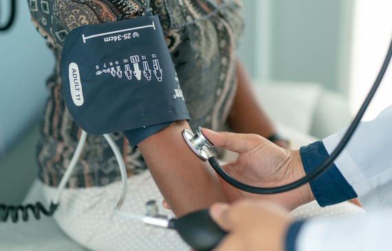 Health professional checking blood pressure