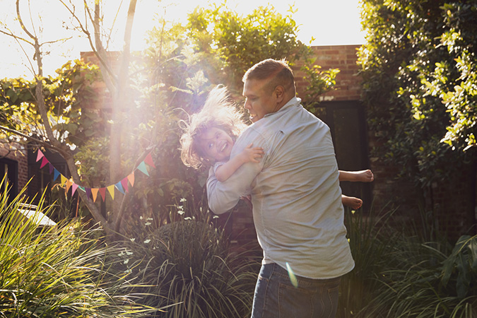 Father and daughter playing in their garden