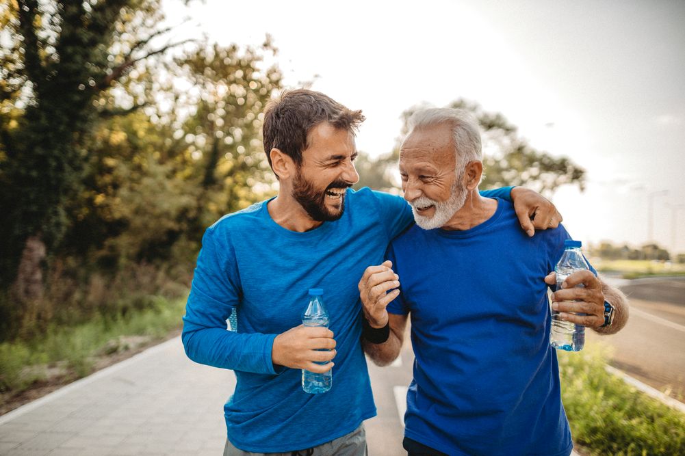 Father and son going for a walk outside, laughing together