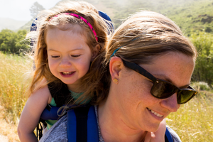 Woman walking with child in backpack