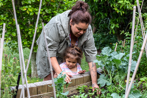 Woman and child working in vegetable garden