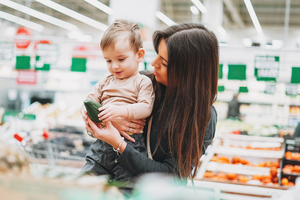 Woman and child selecting vegetables in a store