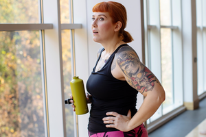 Person in exercise outfit with drink bottle
