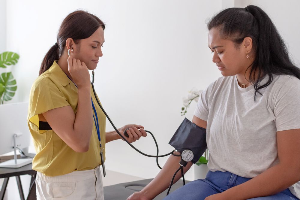 Health professional taking a blood pressure reading of a patient