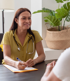 A health professional taking notes while in an appointment