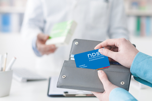 Woman in chemist getting NDSS card out of wallet