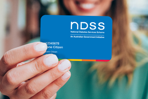 Woman holding a NDSS card