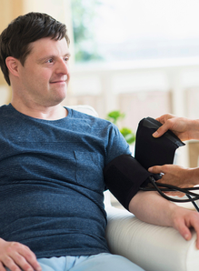 Man having his BP taken as part of his annual cycle of care