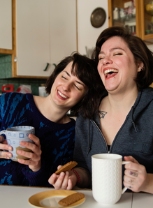 Two people having a coffee and laughing together