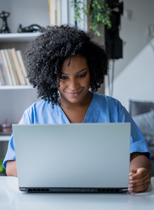 health professional looking at laptop screen