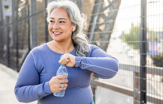 woman drinking water after a workout