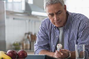 Man looking at medication