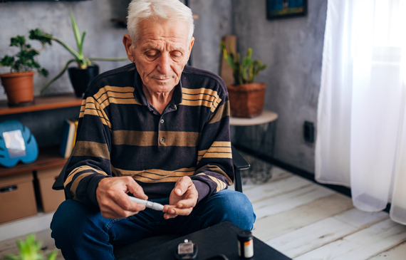 Older man checking his blood glucose levels