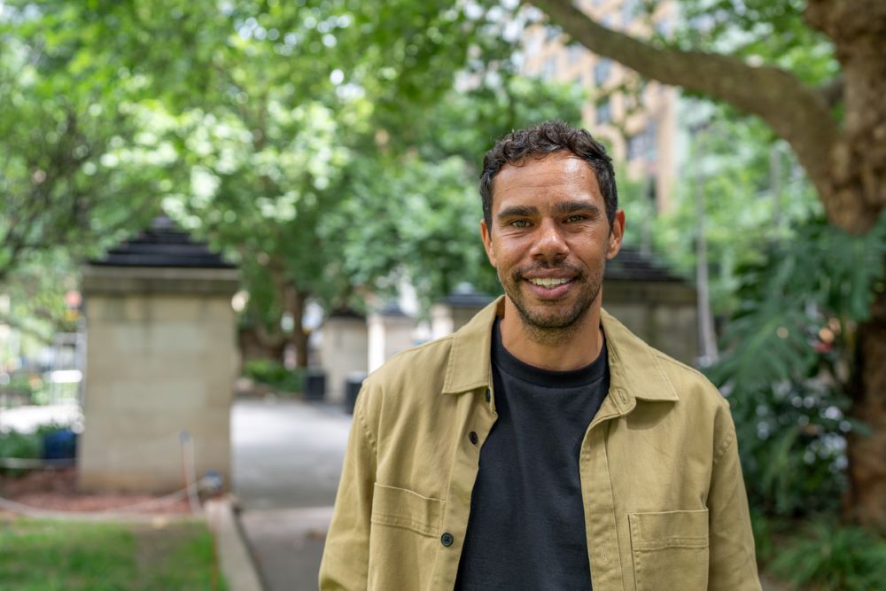 Portrait of a man, standing in a park