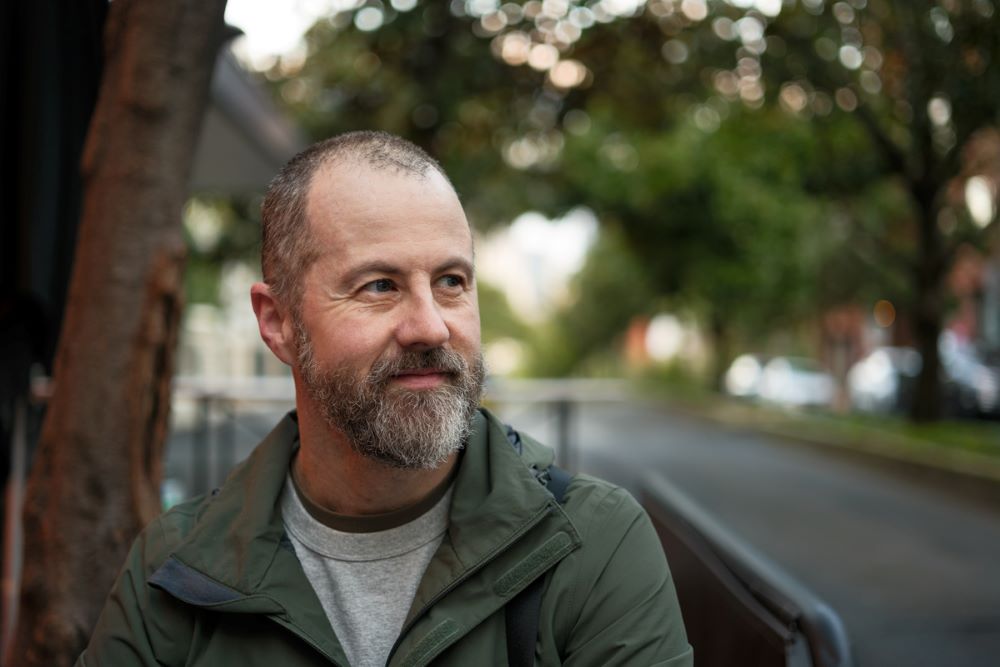 Portrait of a man, standing in park next to bike path