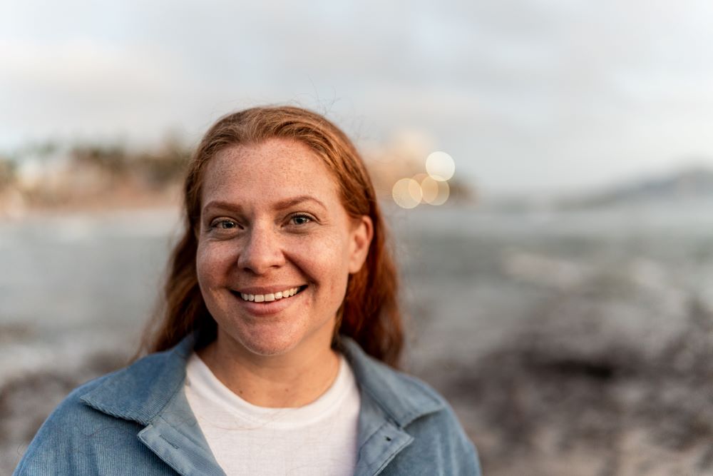 Portrait of woman, standing on a beach