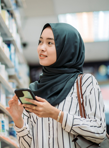 looking at products with hand holding mobile phone