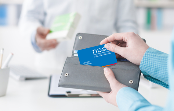 Woman buying medical products in the pharmacy, she is taking the NDSS card from wallet