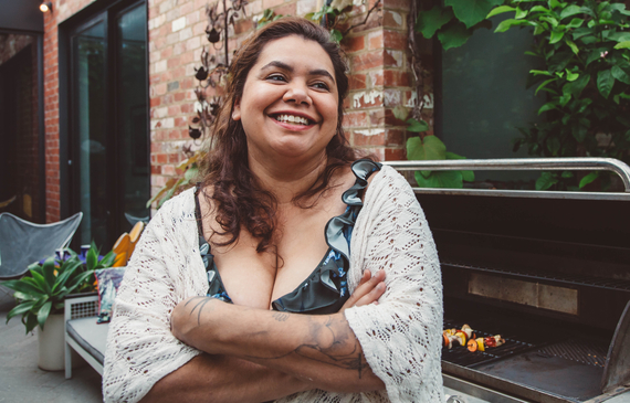 Indigenous Australian mother watching over a family celebration at home