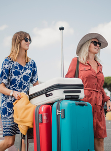 People walking trough the airport parking lot after arriving in Pisa. They are pushing a luggage cart and taking in their surroundings.