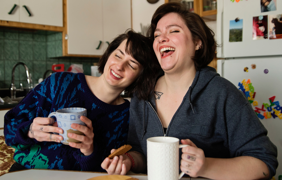 People laughing and enjoying a coffee together
