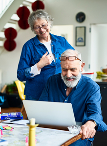 Older couple looking at information on a laptop