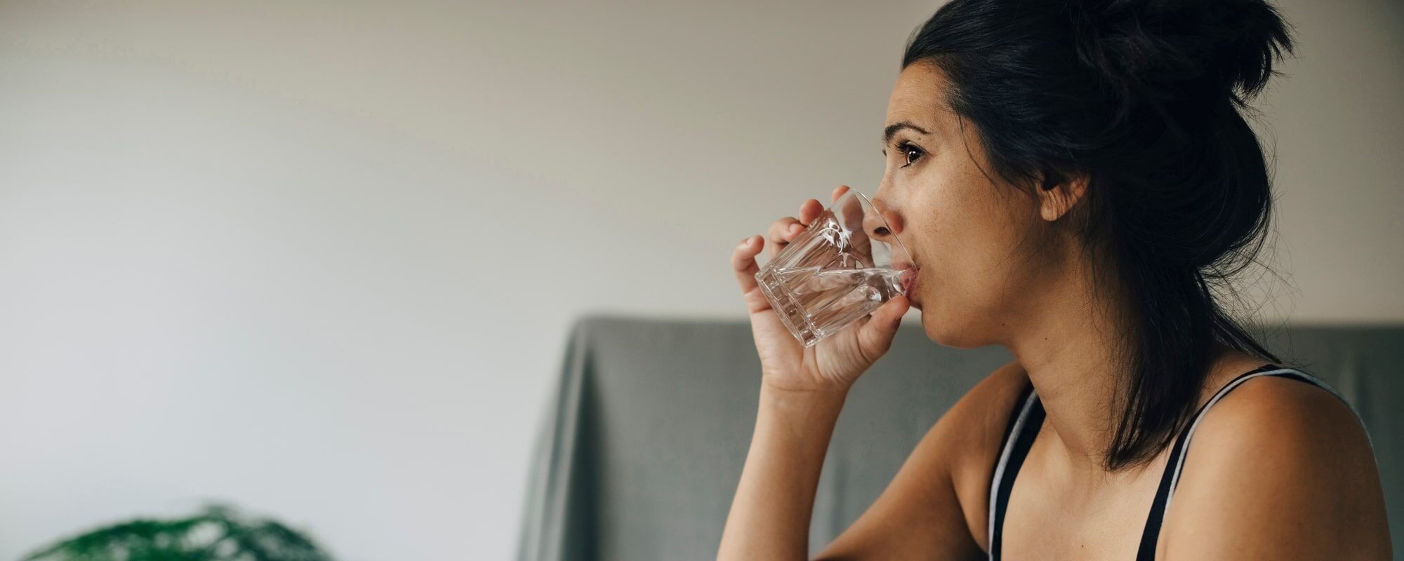 woman-drinking-water-from-a-glass-min